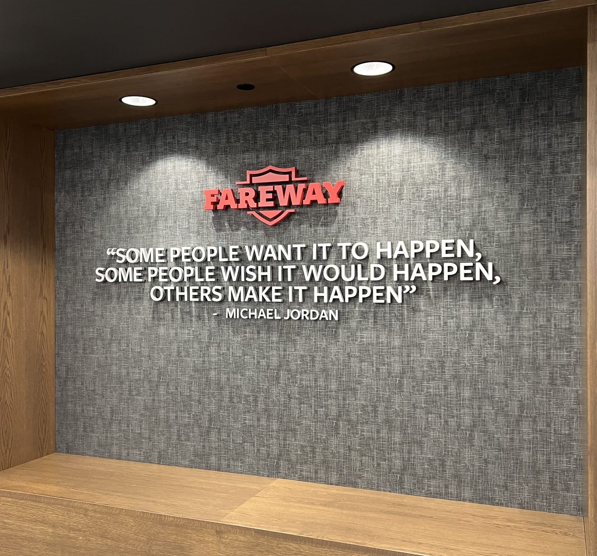 Fareway brand with Michael Jordan quote. Dimensional lettering on wall with a wood bench.