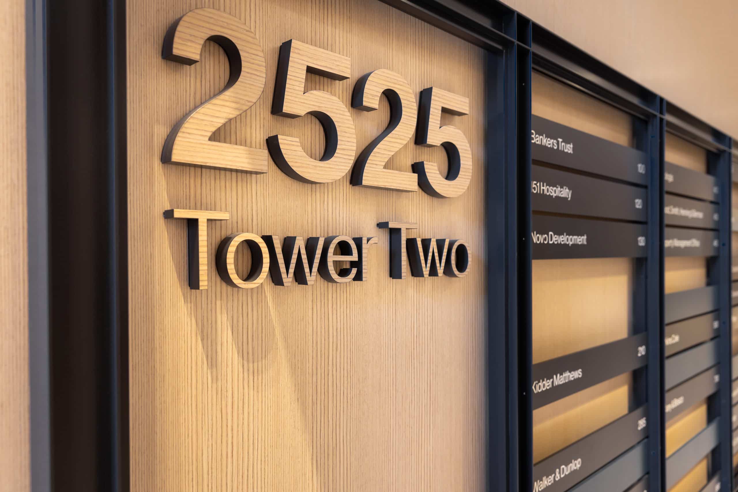 Wood-grain dimensional lettering for interior corporate office directory.